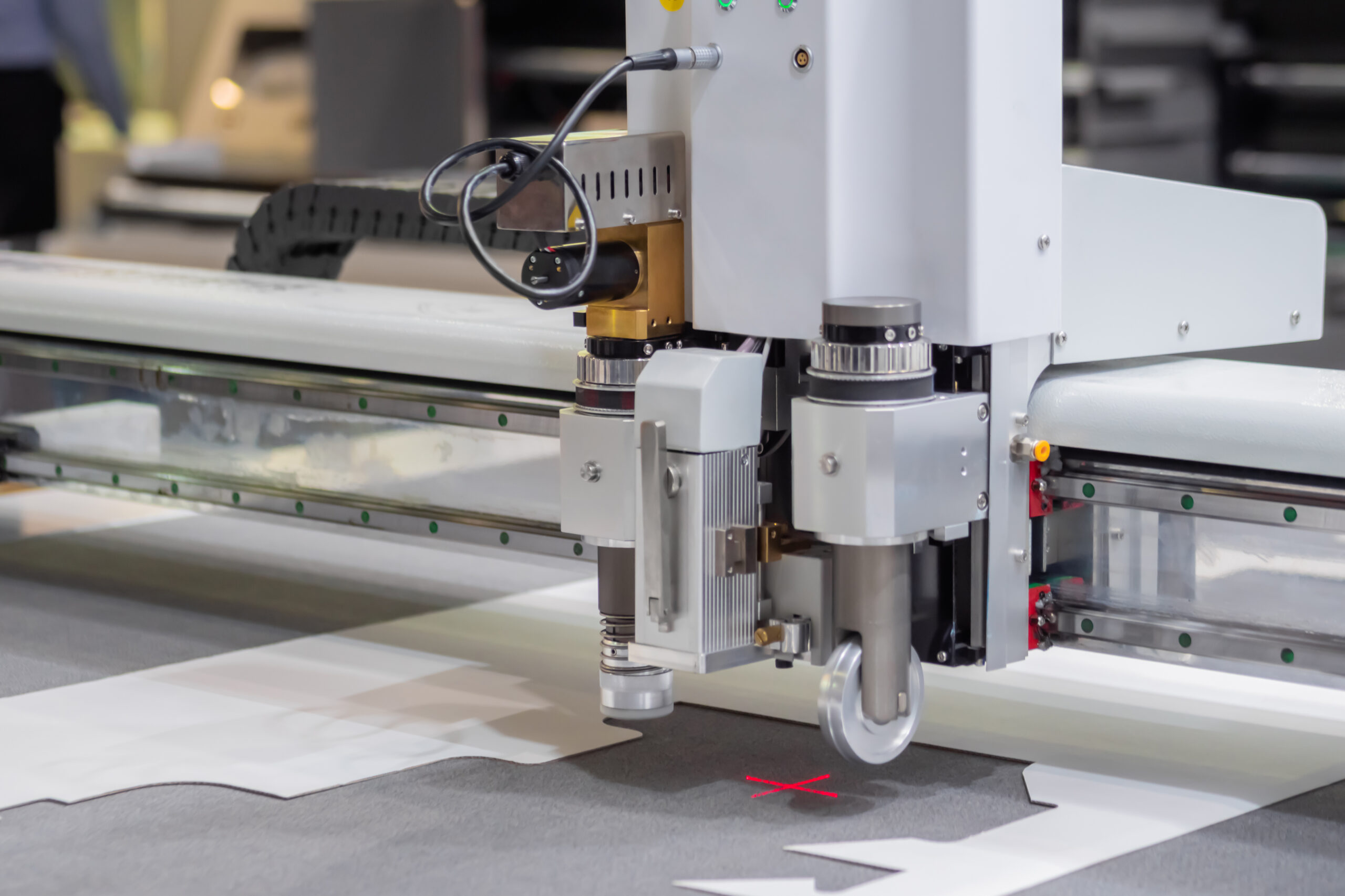 Automated CNC machine cutting fabric with precision in a modern industrial setting.