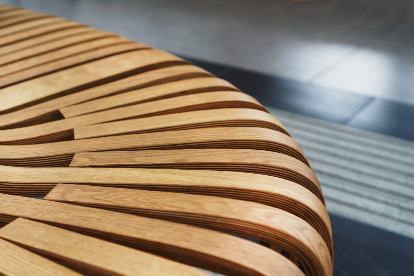 Curved wooden slats in intricate pattern, highlighting modern design and craftsmanship.